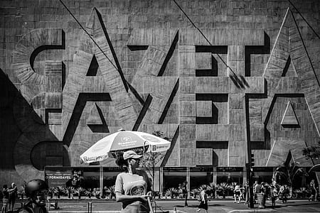 woman standing in front of umbrella thumbnail