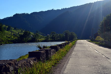 road near river during daytime thumbnail
