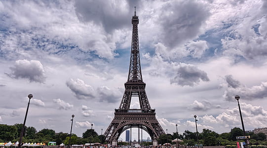 Eiffel tower across cloudy sky thumbnail