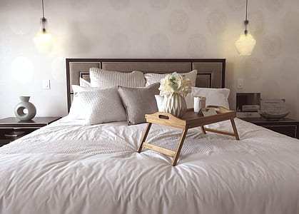 brown wooden bed tray table on white sheet covered bed thumbnail