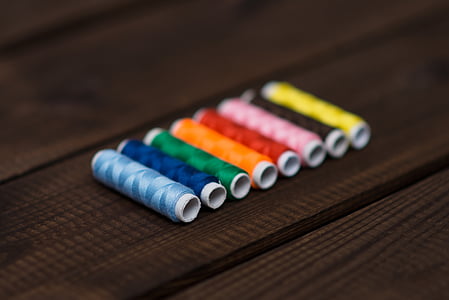 assorted-color threads on floor thumbnail