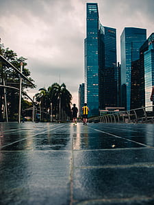 two men walking on black concrete road thumbnail