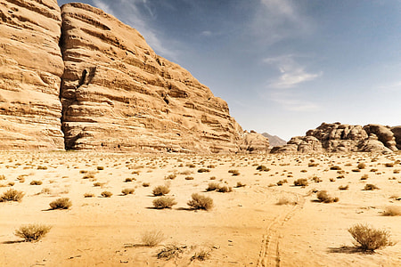 landscape photo of brown cliff formation under cloudy sky during daytime thumbnail
