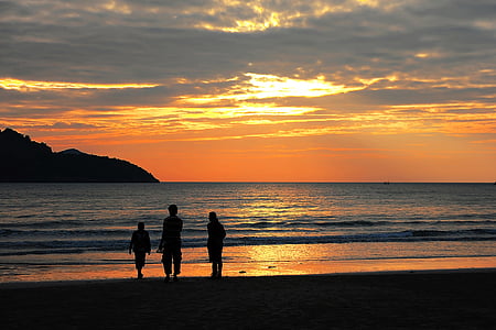 silhouette of three people near in the beach thumbnail
