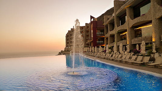fountain turned-on near building at daytime thumbnail