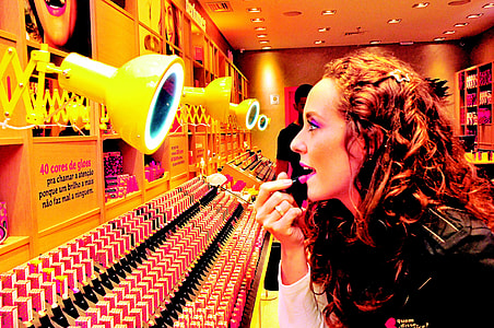 woman trying out lipstick inside store thumbnail