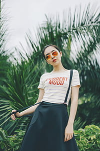 woman beside bush near palm tree thumbnail