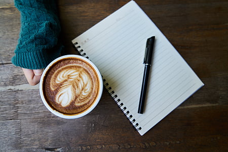 photo of black pen on white spring note book near cup of cappuccino thumbnail