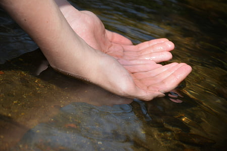 person soaking its both hands on water thumbnail
