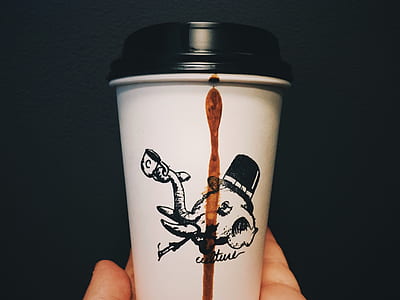 person holding white and black coffee cup thumbnail