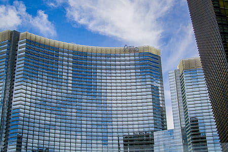 Clear Glass Building Under Blue and Cloudy Sky during Daytime thumbnail