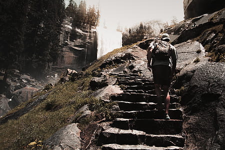 man climbing up stone stair steps during daytime thumbnail