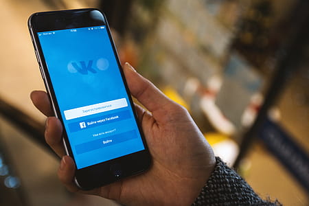 Display with login to the social network Vkontakte on modern smartphone in hands thumbnail