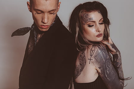 man and woman standing side-by-side posing for a photo shoot thumbnail