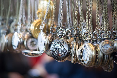 selective focus photography of hanging pocket watch thumbnail