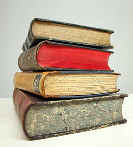 four assorted books stacked thumbnail