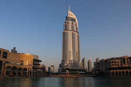 low angle photography of high rise building near body of water thumbnail