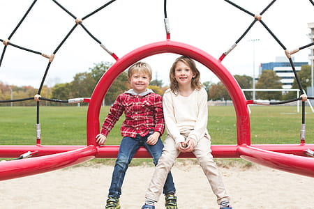Siblings Smiling At Park Photo thumbnail