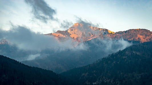 foggy mountains under blue sky thumbnail