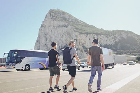 three men walking on park thumbnail