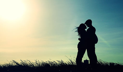 silhouette of man and woman on grass thumbnail