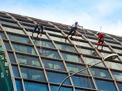 three men cleaning glass wall building thumbnail
