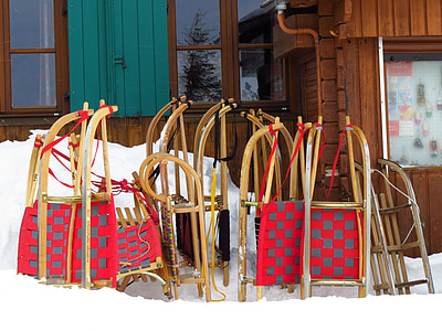 brown and red sled lot leaning on wall thumbnail