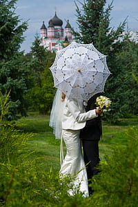 couple sharing umbrella during daytime thumbnail