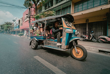 man riding auto rickshaw thumbnail