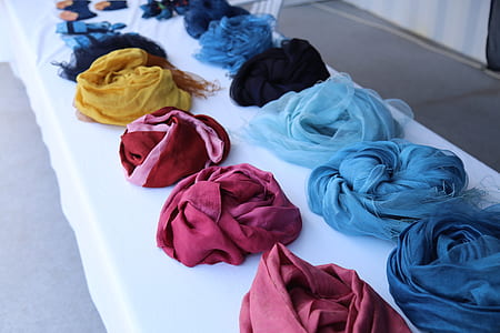 assorted colored textiles lined on white textile thumbnail