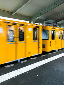 moving orange train on train station thumbnail