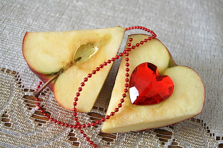 two heart shaped apples on white surface thumbnail