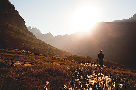 man near mountains taken during daytime thumbnail