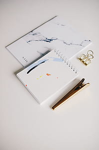 white pocket notebook with gray metal clip thumbnail