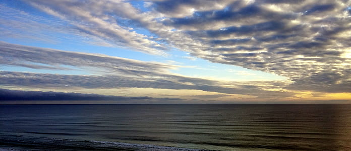 White Sky Under Blue Sea during Dawn thumbnail