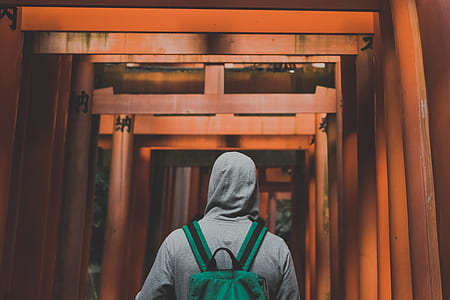 person wearing green backpack thumbnail