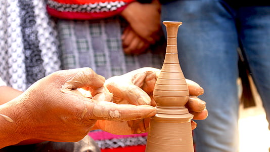 closeup photography of person making brown clay pot thumbnail