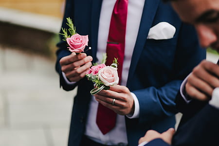 shallow focus photography of man holding pink roses thumbnail