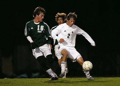 time lapse photo of three soccer players on field thumbnail