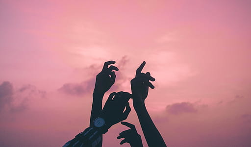 person raising hands at sunset thumbnail