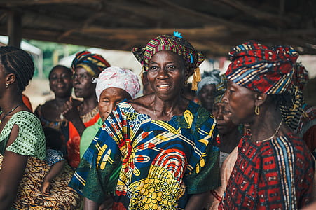 group of women wearing traditional dresses while standing thumbnail