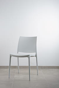 white chair in front of white wall thumbnail