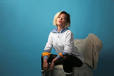 Woman Sitting on Chair Near Wall thumbnail