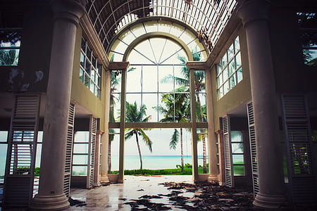 empty building with glass window near sea at daytime thumbnail