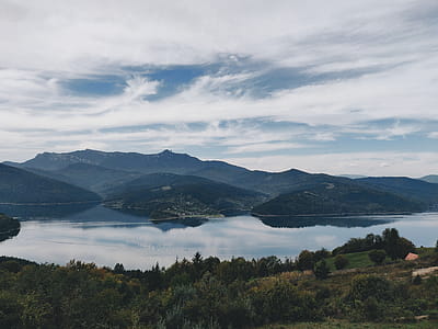 Top View of Lake Surrounded by Trees and Mountains thumbnail