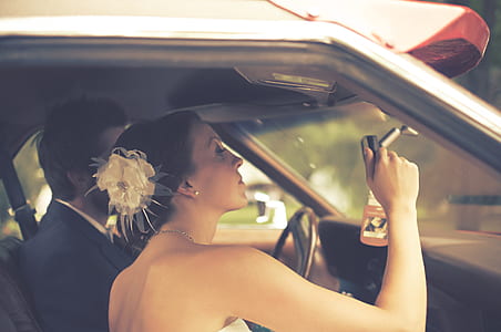 lomo photography of woman wearing strapless dress looking her face on vehicle's rear view mirror thumbnail
