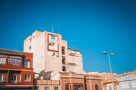 white concrete building under blue sky thumbnail