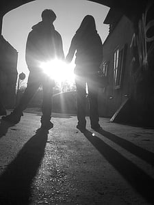 silhouette of man and woman holding hands thumbnail