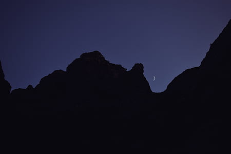 silhouette of mountain during night time thumbnail