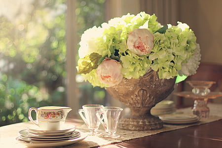 green hydrangea and pink buttercup flower arrangement and clear glasses thumbnail